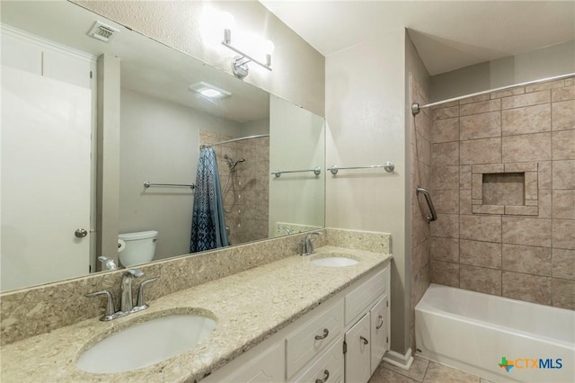 full bath featuring toilet, visible vents, shower / bath combo with shower curtain, and a sink