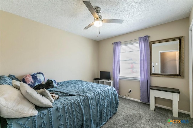 carpeted bedroom featuring a ceiling fan, a textured ceiling, and baseboards