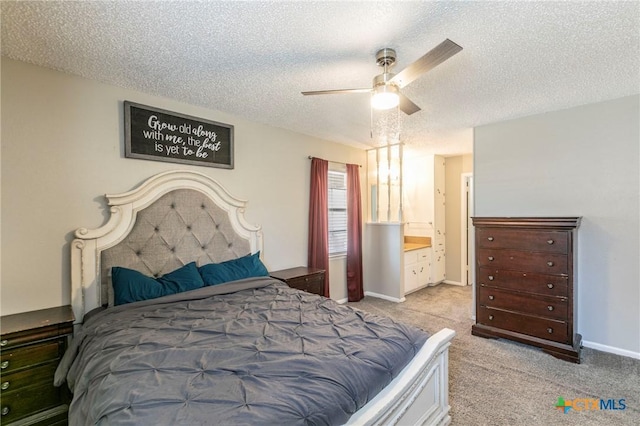 bedroom with light carpet, ceiling fan, baseboards, and a textured ceiling