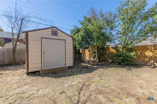 view of shed with a fenced backyard