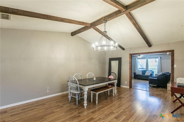 dining room featuring vaulted ceiling with beams, visible vents, an inviting chandelier, wood finished floors, and baseboards