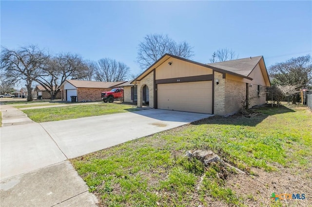 view of front of house with a garage, concrete driveway, brick siding, and a front lawn