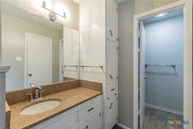 bathroom featuring baseboards and vanity