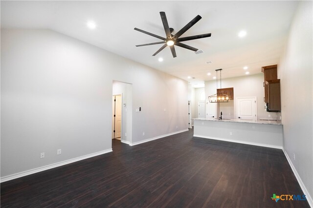 unfurnished living room with dark wood-type flooring, sink, and ceiling fan with notable chandelier