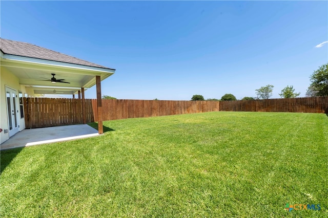 view of yard featuring ceiling fan and a patio area