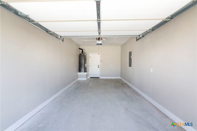 garage with a garage door opener, electric panel, and water heater