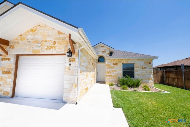 view of front facade with a front yard and a garage