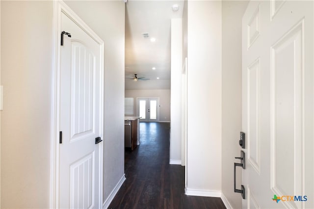 corridor featuring dark hardwood / wood-style floors and french doors