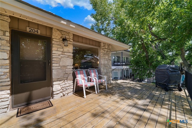 wooden terrace featuring grilling area