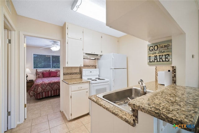 kitchen with white appliances, sink, white cabinets, kitchen peninsula, and ceiling fan