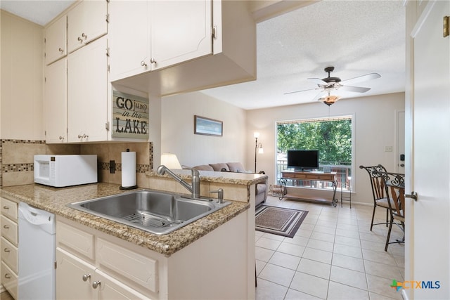 kitchen with white cabinetry, white appliances, sink, kitchen peninsula, and ceiling fan