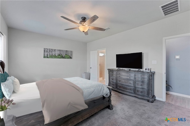 bedroom featuring connected bathroom, ceiling fan, and carpet flooring