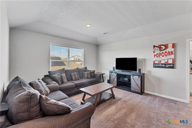 living room featuring light carpet, vaulted ceiling, a raised ceiling, and a textured ceiling