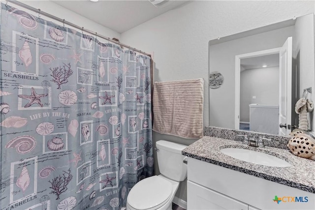 bathroom with vanity, walk in shower, and toilet