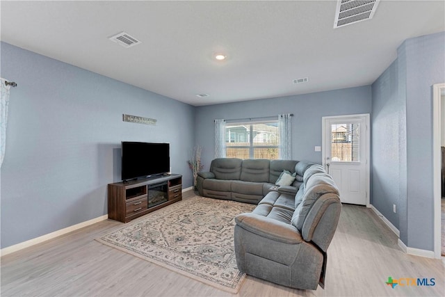 living room with light hardwood / wood-style floors