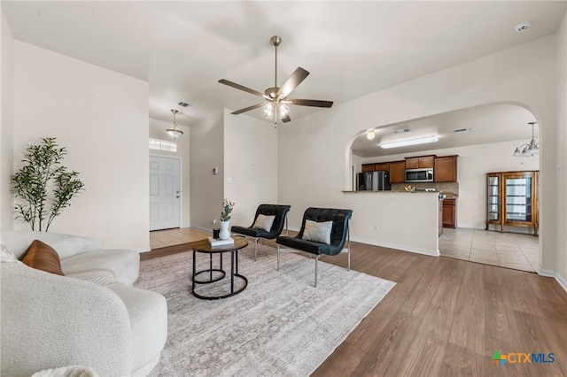 8003 Bridgepointe Dr, Temple, TX 76502 - living area with arched walkways, light wood-style floors, plenty of natural light, and visible vents
