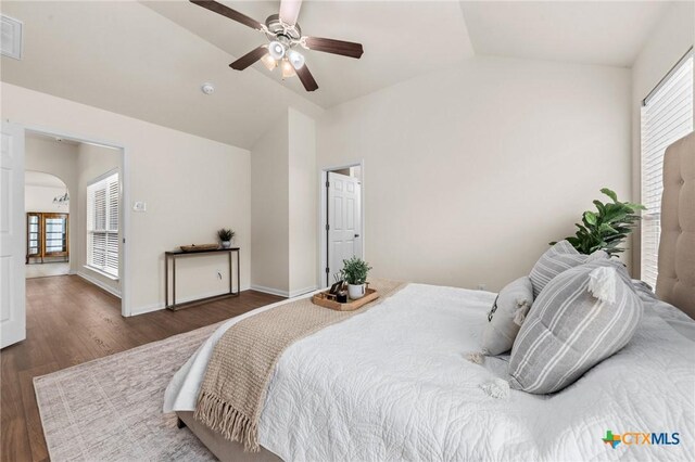 8003 Bridgepointe Dr, Temple, TX 76502 - bedroom with vaulted ceiling, wood finished floors, and multiple windows