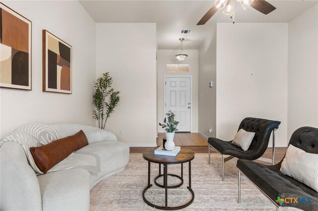 8003 Bridgepointe Dr, Temple, TX 76502 - living area featuring wood finished floors, visible vents, a ceiling fan, and baseboards