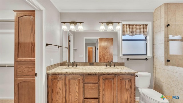 bathroom featuring vanity, toilet, and crown molding