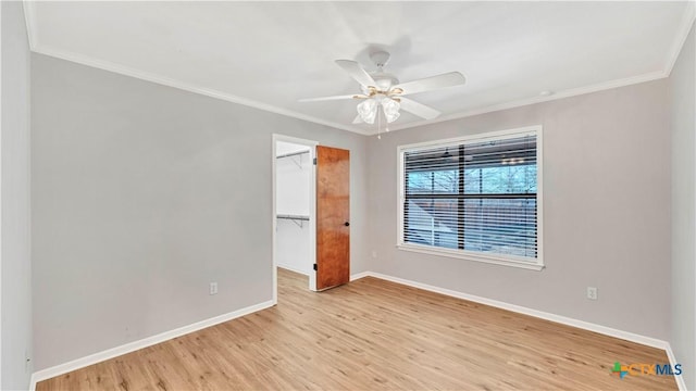 spare room featuring light hardwood / wood-style flooring, ceiling fan, and crown molding