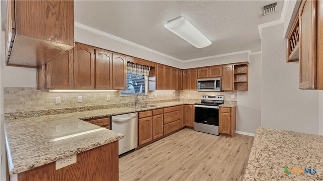 kitchen featuring crown molding, sink, light hardwood / wood-style flooring, appliances with stainless steel finishes, and light stone counters