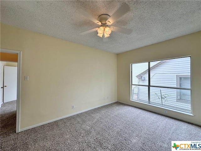 empty room featuring a textured ceiling, carpet floors, and ceiling fan