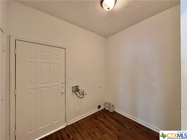 clothes washing area featuring washer hookup, dark hardwood / wood-style floors, and a textured ceiling