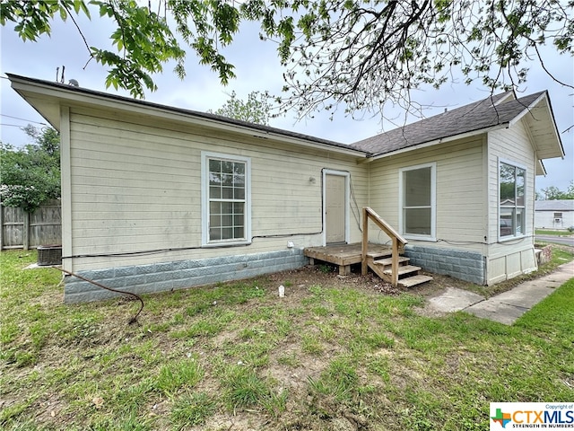 back of house with a lawn