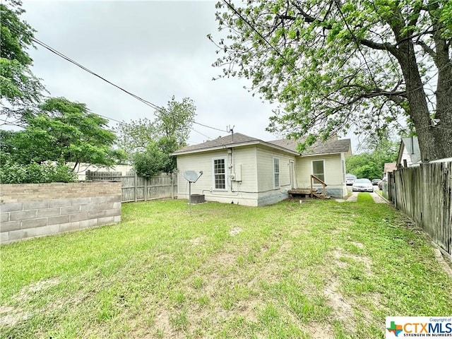 rear view of house with a yard