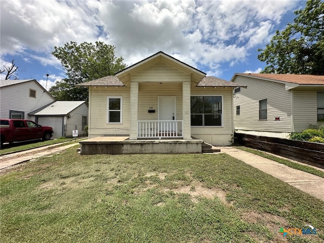 bungalow-style home with a front lawn and a porch