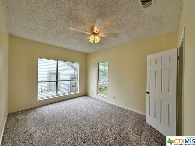 carpeted empty room with a textured ceiling and ceiling fan