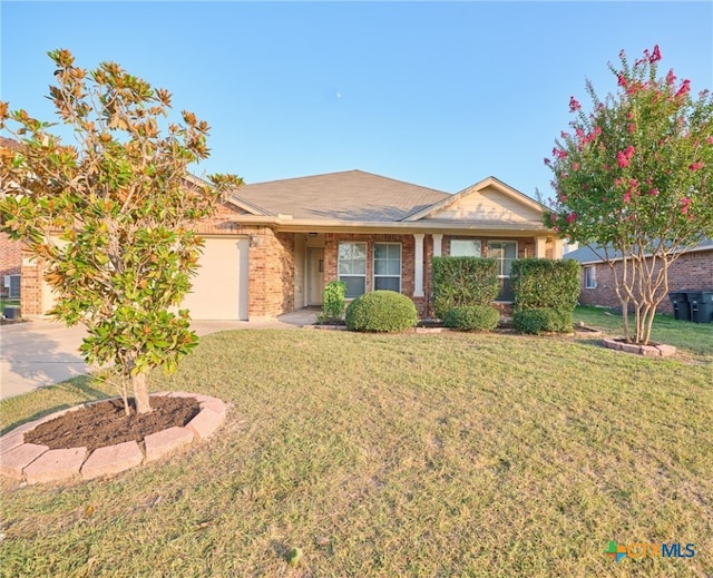 ranch-style house featuring a front lawn and a garage