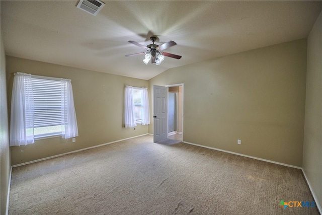 carpeted spare room with lofted ceiling and ceiling fan