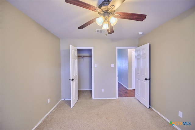 unfurnished bedroom with a closet, light carpet, and ceiling fan