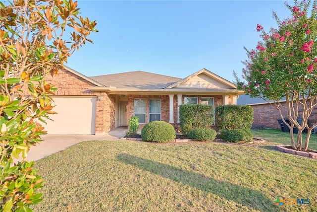 single story home featuring a garage and a front lawn