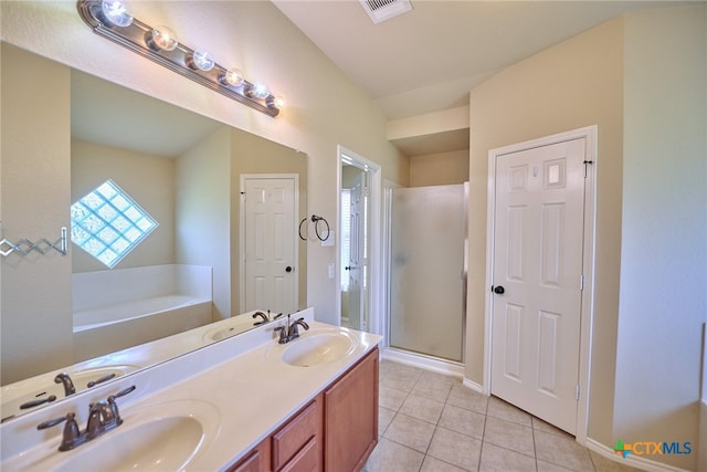 bathroom featuring tile patterned flooring, vanity, and separate shower and tub