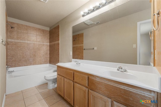 bathroom featuring a sink, bathing tub / shower combination, tile patterned flooring, and toilet