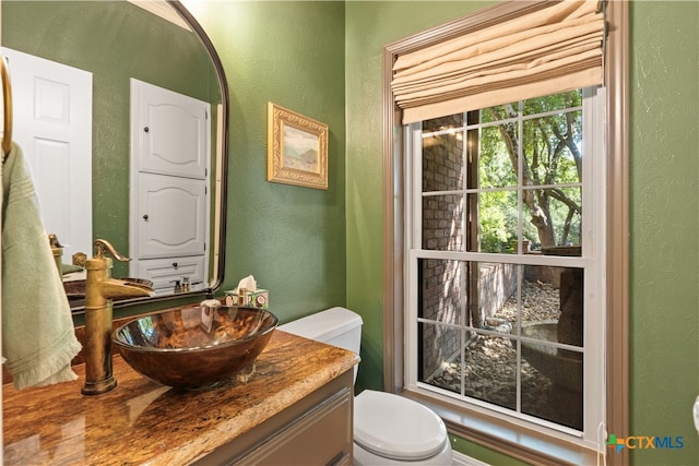 bathroom featuring toilet and vanity