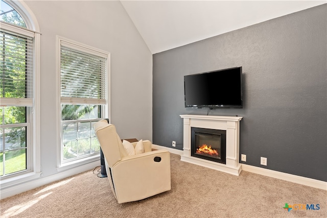 sitting room featuring light colored carpet, plenty of natural light, and lofted ceiling