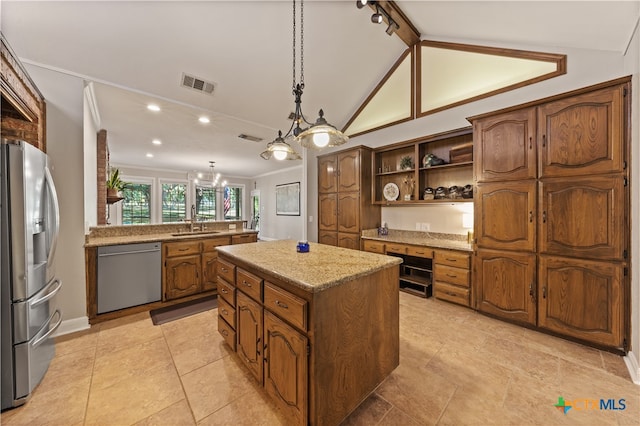 kitchen featuring appliances with stainless steel finishes, hanging light fixtures, sink, lofted ceiling, and a center island