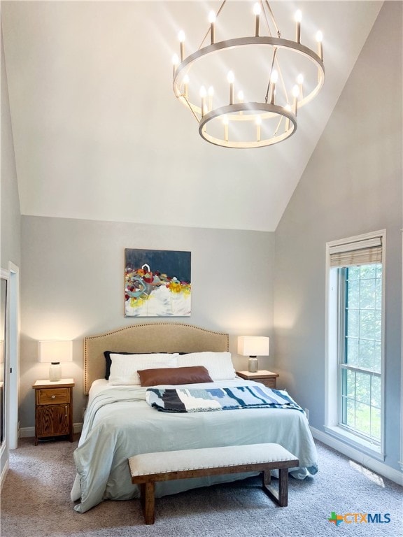 bedroom with high vaulted ceiling, an inviting chandelier, and light colored carpet