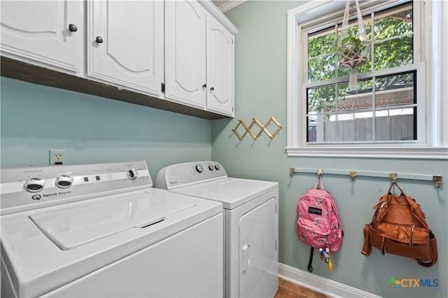 clothes washing area featuring cabinets, tile patterned floors, and separate washer and dryer