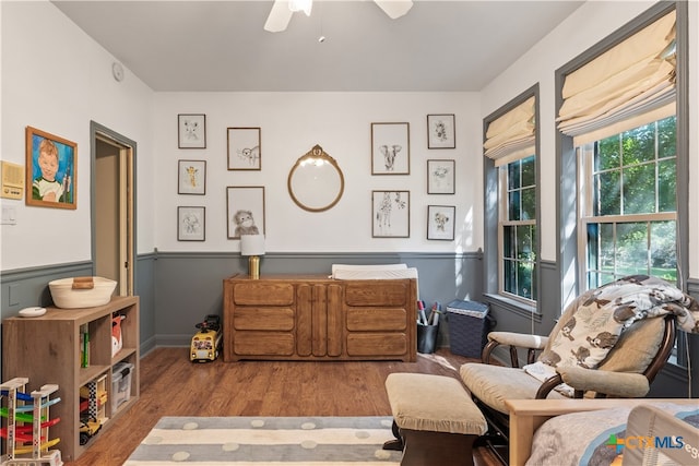 sitting room featuring light hardwood / wood-style floors and ceiling fan