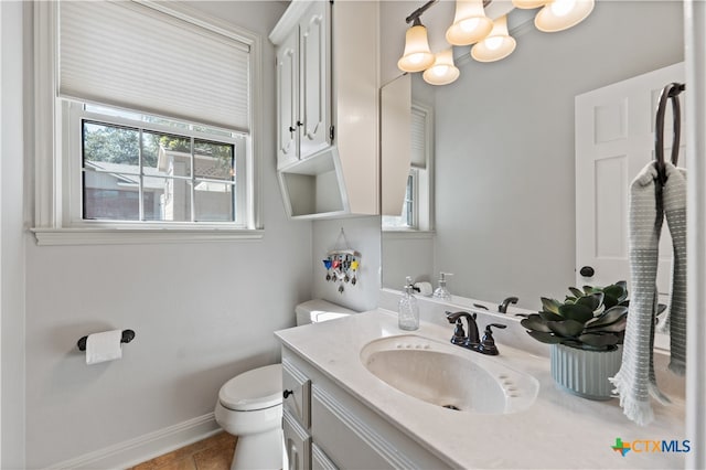 bathroom featuring vanity, tile patterned floors, and toilet