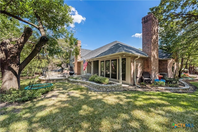 back of property featuring a patio and a yard