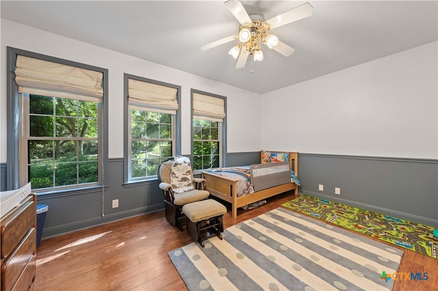 bedroom featuring ceiling fan and dark hardwood / wood-style floors