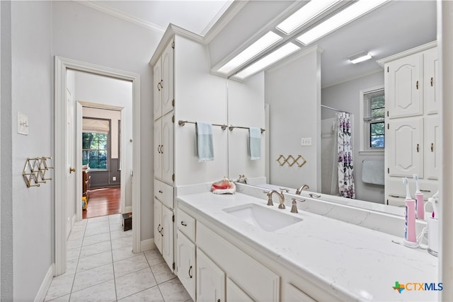 bathroom featuring walk in shower, vanity, tile patterned floors, and crown molding