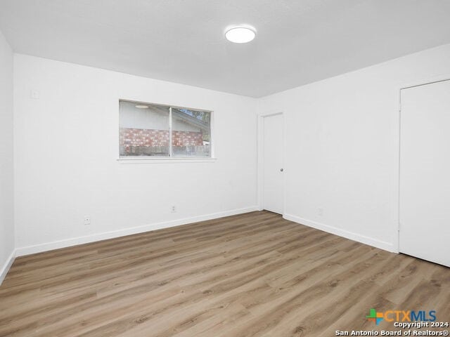 spare room featuring light hardwood / wood-style floors