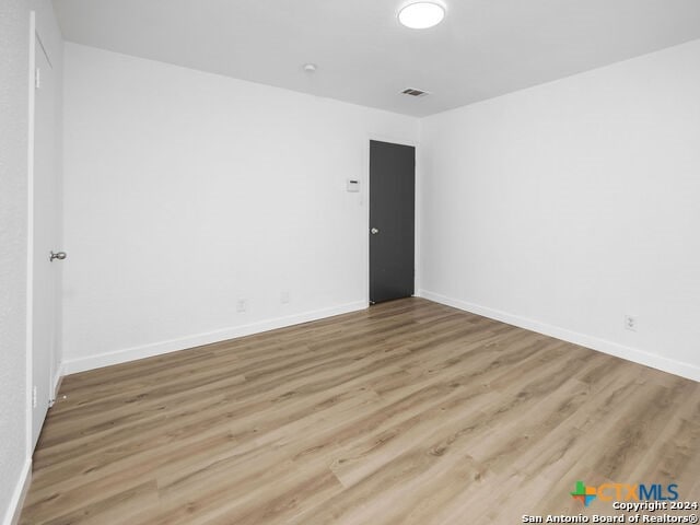 spare room with hardwood / wood-style flooring