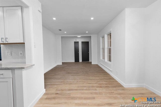 corridor featuring light hardwood / wood-style floors